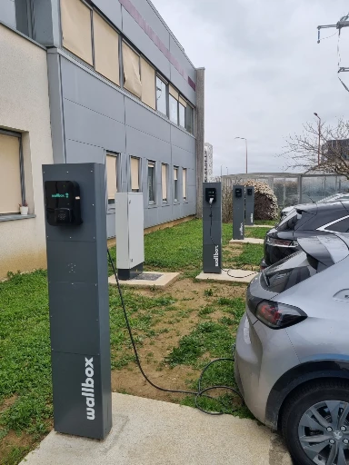 voitures d'entreprise en plein chargement sur borne wallbox sur un parking